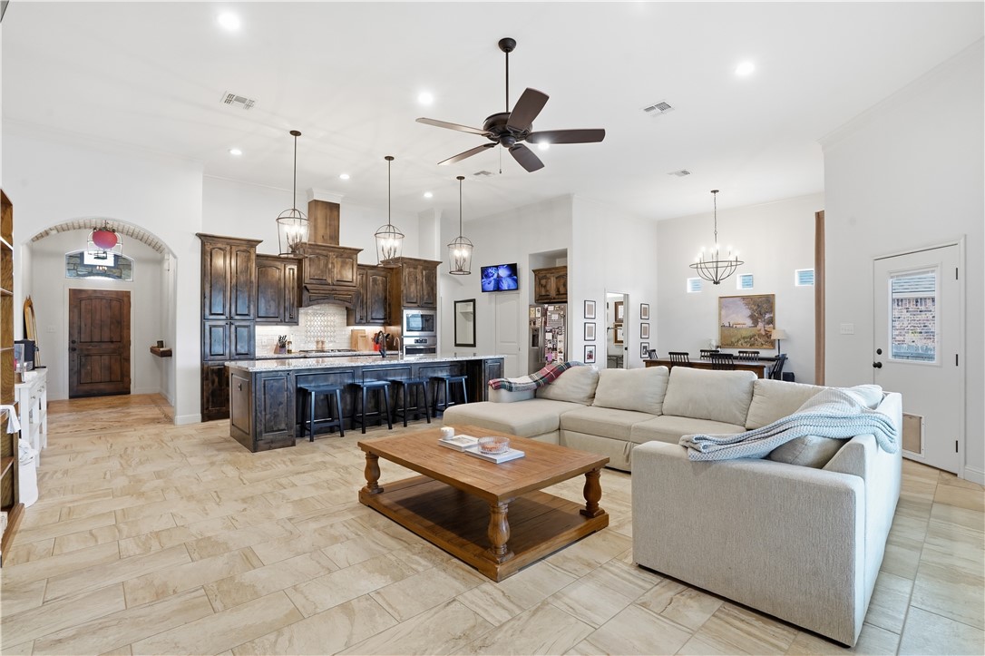 3516 Foxcroft Path Bryan, TX 77808 - Photo 7 of 38 a living room with furniture kitchen view and a chandelier