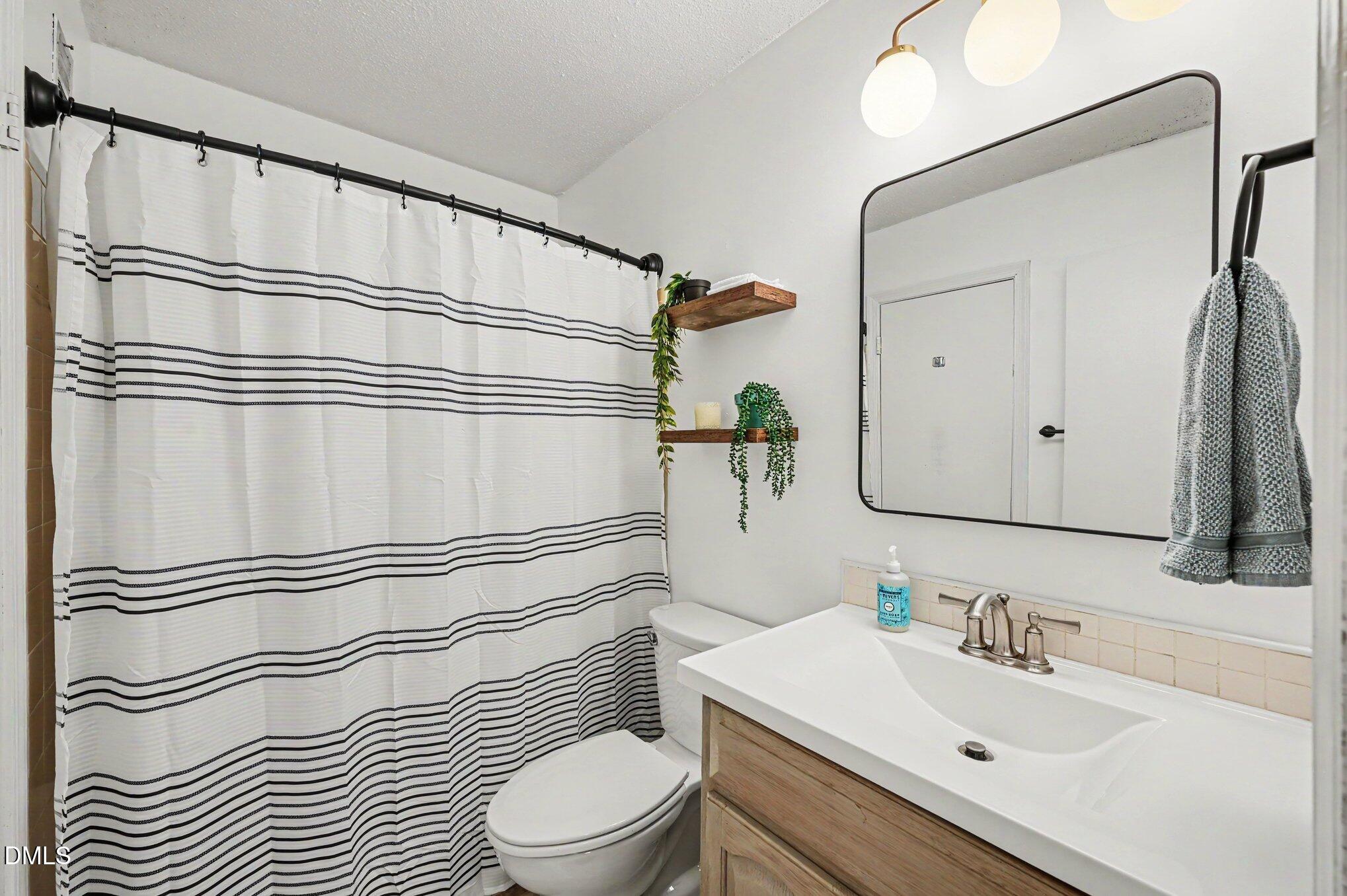 807 West Trinity Avenue, Unit 252 Durham, NC 27701 - Photo 8 of 23 a bathroom with a sink toilet and shower