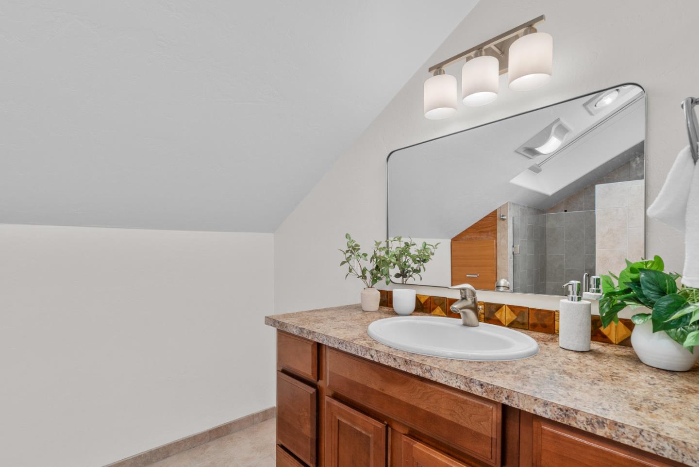 1695 Aptos Creek Road Aptos, CA 95003 - Photo 58 of 76 a bathroom with a granite countertop sink and a mirror