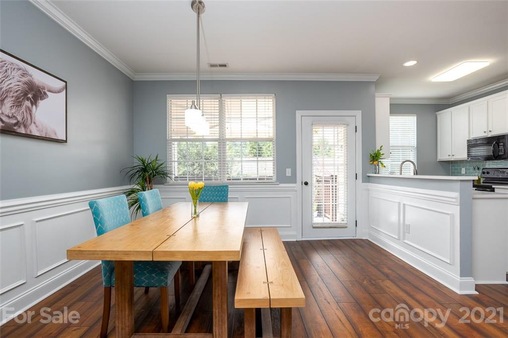 131 High Ridge Road Mooresville, NC 28117 - Photo 11 of 40 a kitchen with a table chairs refrigerator and microwave