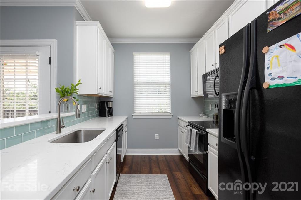 131 High Ridge Road Mooresville, NC 28117 - Photo 15 of 40 a kitchen that has a sink a stove and a refrigerator