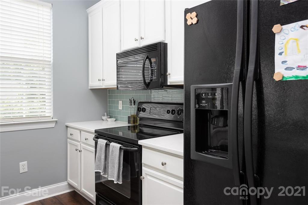 131 High Ridge Road Mooresville, NC 28117 - Photo 16 of 40 a kitchen with a stove and a microwave