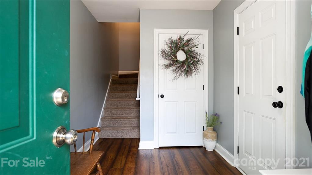 131 High Ridge Road Mooresville, NC 28117 - Photo 3 of 40 a view of a hallway with wooden floor and stairs