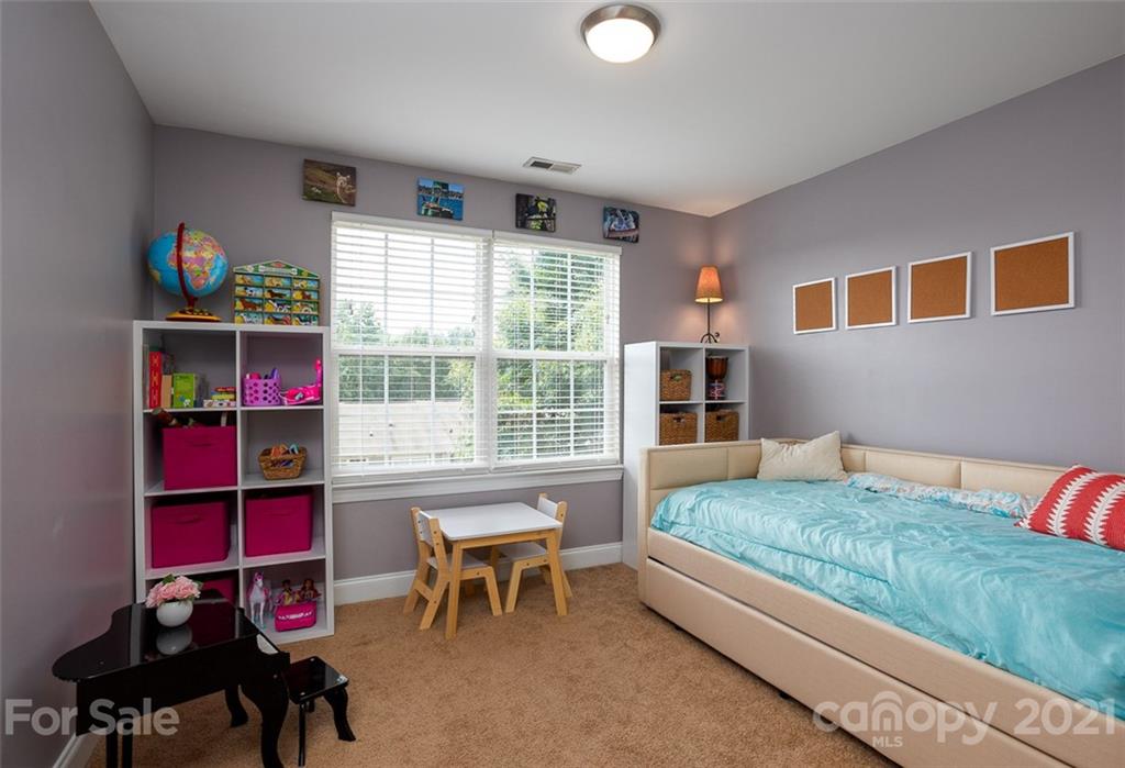 131 High Ridge Road Mooresville, NC 28117 - Photo 21 of 40 a bedroom with furniture and a large window