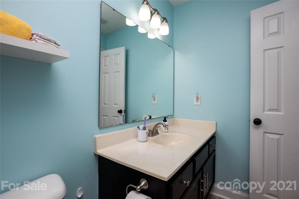 131 High Ridge Road Mooresville, NC 28117 - Photo 25 of 40 a bathroom with a sink and a mirror