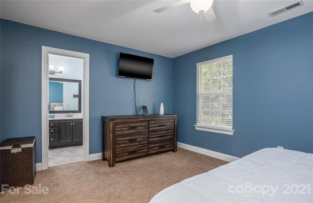 131 High Ridge Road Mooresville, NC 28117 - Photo 28 of 40 a bedroom with a bed and a flat screen tv