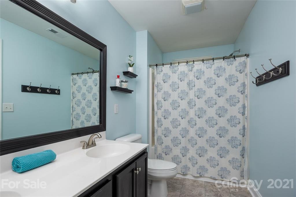 131 High Ridge Road Mooresville, NC 28117 - Photo 29 of 40 a bathroom with a sink and a mirror