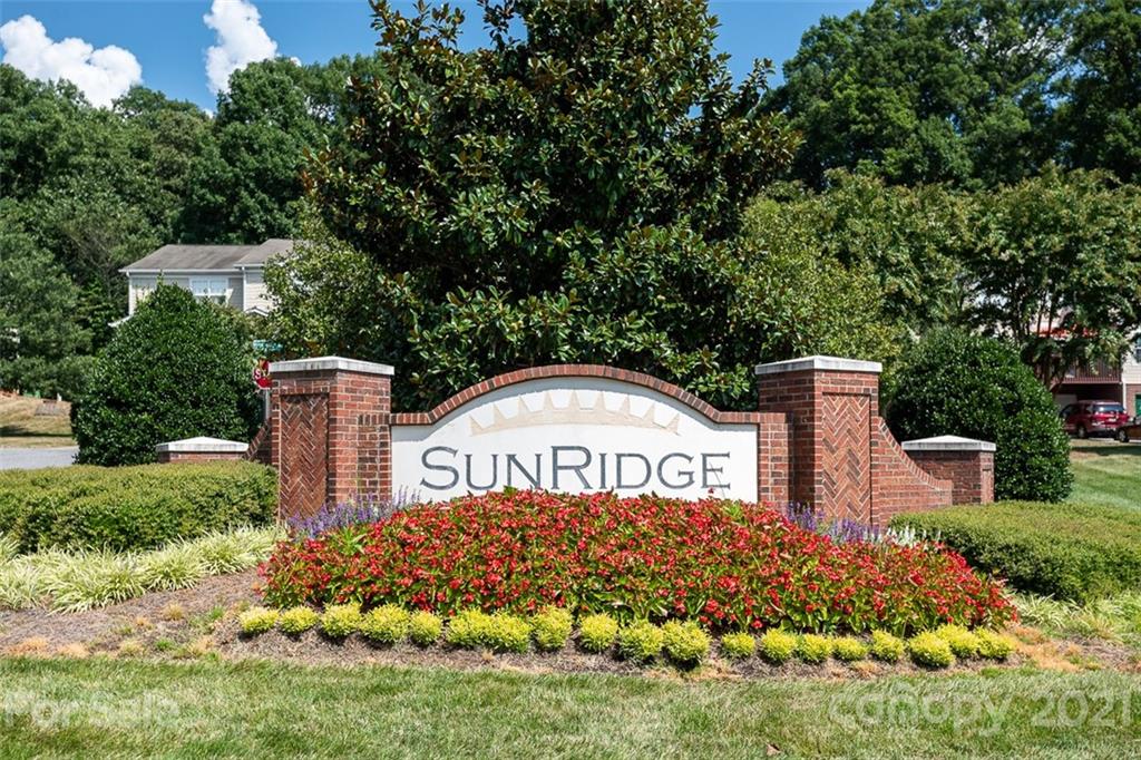 131 High Ridge Road Mooresville, NC 28117 - Photo 36 of 40 a view of front of house with sign board and yard