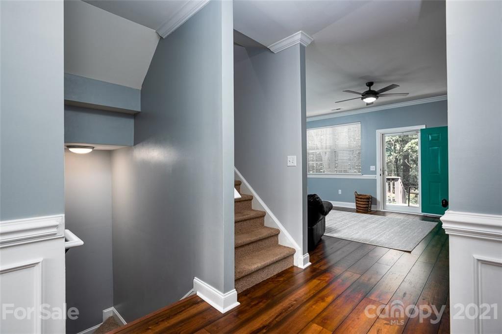 131 High Ridge Road Mooresville, NC 28117 - Photo 5 of 40 a view of a hallway with wooden floor and staircase