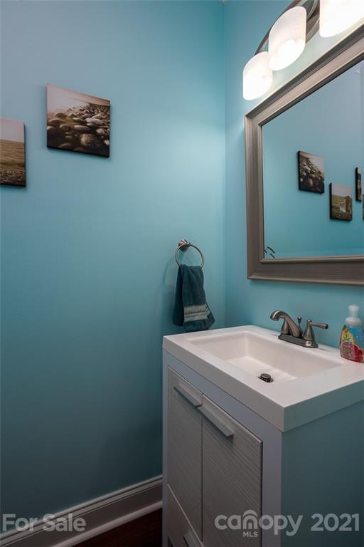 131 High Ridge Road Mooresville, NC 28117 - Photo 9 of 40 a bathroom with a sink and a mirror