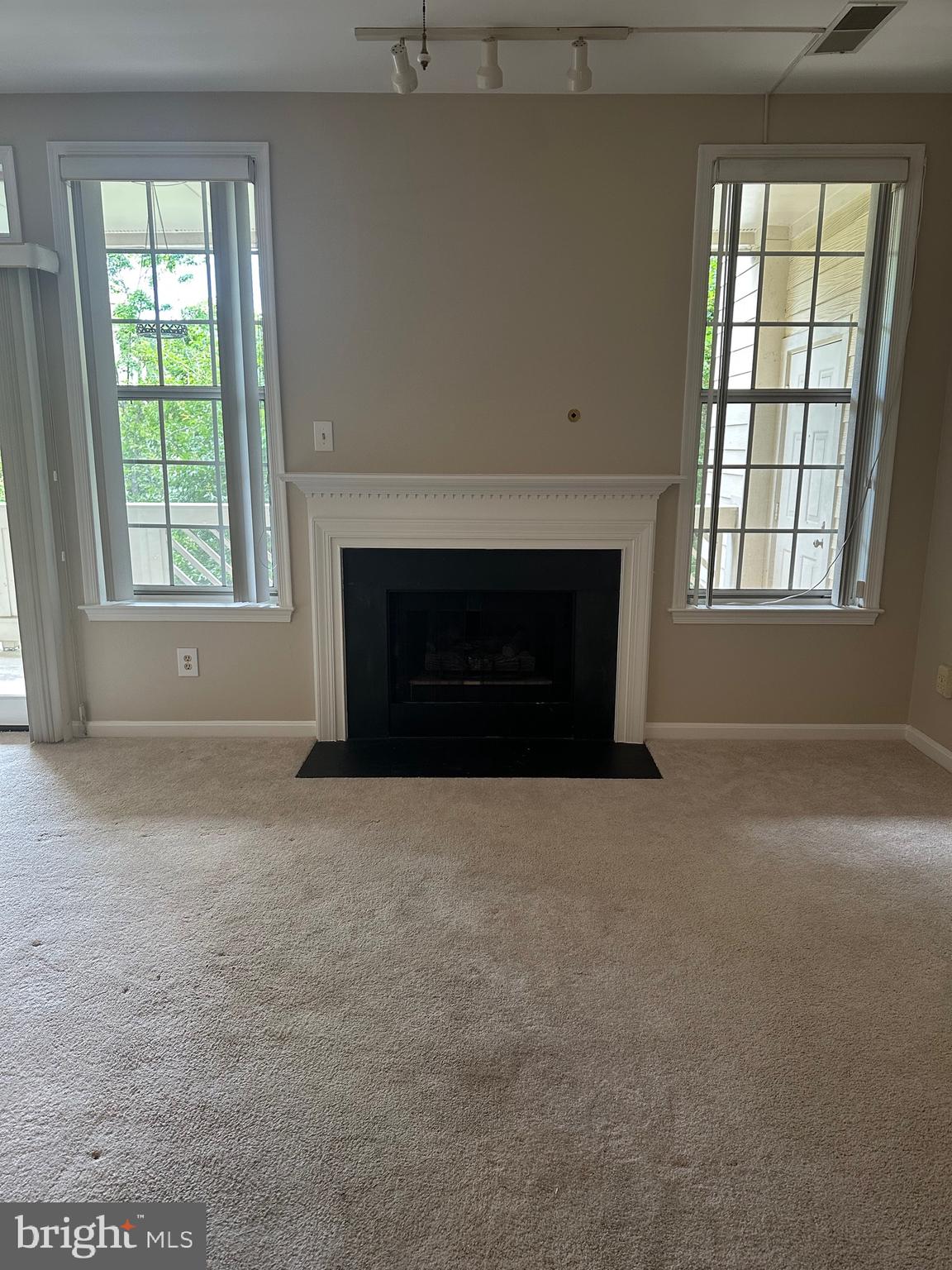 1324D Garden Wall Circle, Unit 306 Reston, VA 20194 - Photo 2 of 12 an empty room with windows and fireplace