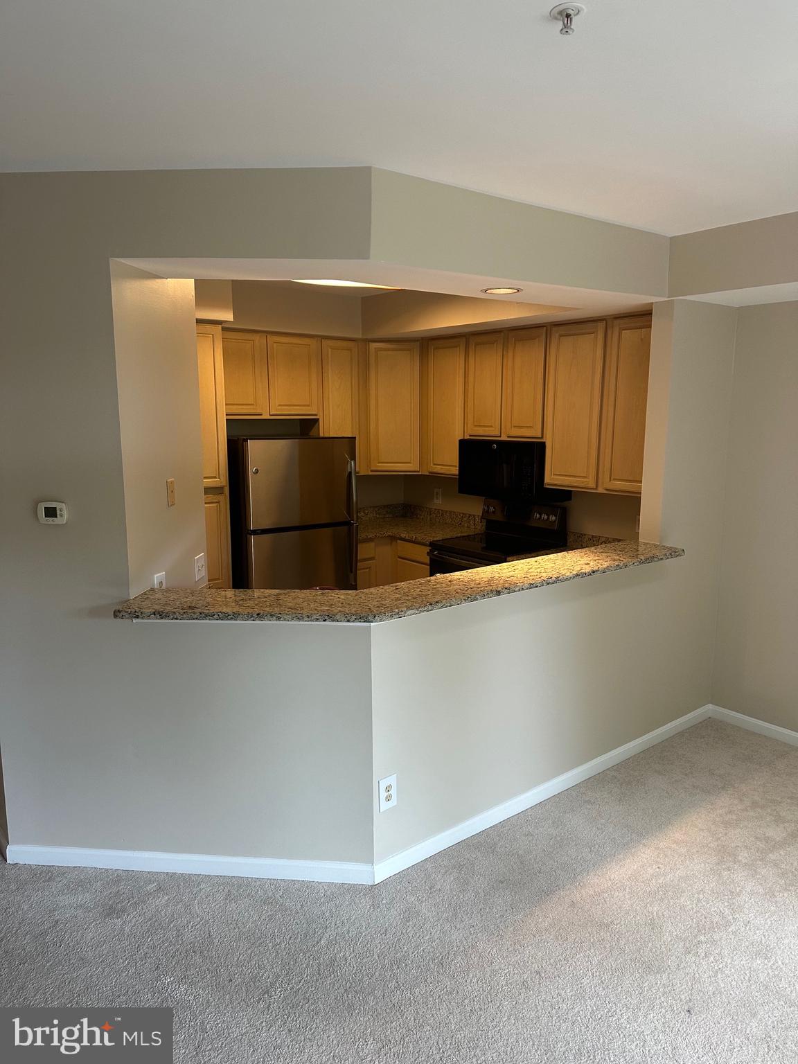 1324D Garden Wall Circle, Unit 306 Reston, VA 20194 - Photo 4 of 12 a kitchen with stainless steel appliances granite countertop a refrigerator and a sink
