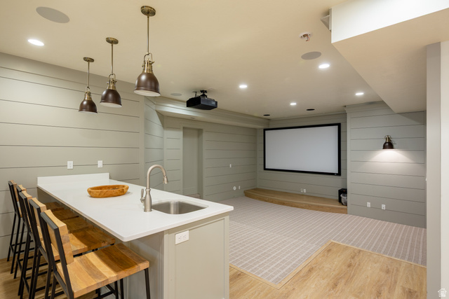 630 East Center Street Alpine, UT 84004 - Photo 62 of 115 Entertainment space featuring a white quartz-finish island with integrated sink, three industrial-style pendant lights, shiplap wall accents, a projector screen, and recessed lighting