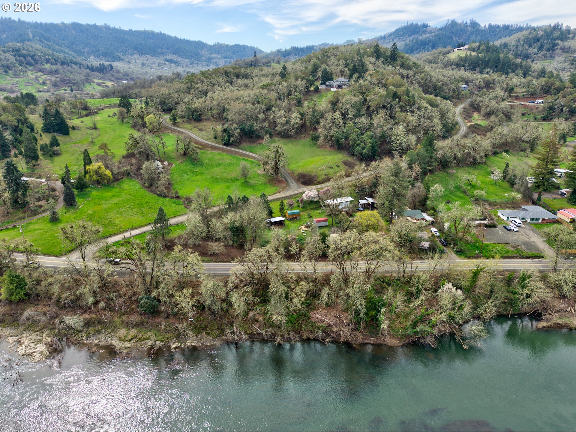 4178 Old Melrose Road Roseburg, OR 97471 - Photo 19 of 19 an aerial view of green landscape with trees houses and lake view