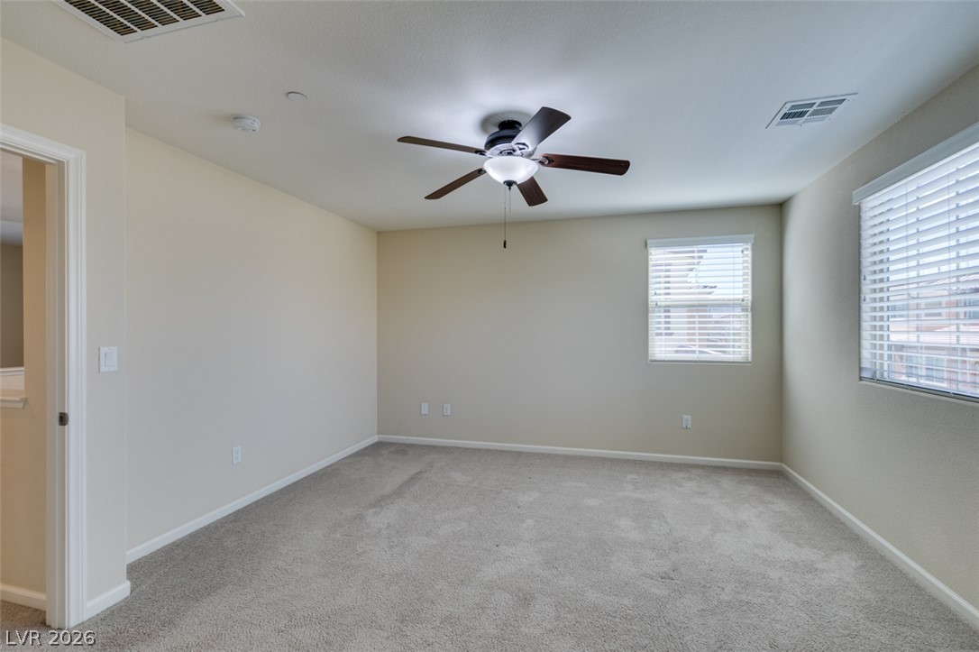 2549 Sable Ridge Street Henderson, NV 89044 - Photo 42 of 48 A spacious room featuring comfortable carpeted floors and a modern ceiling fan for optimal airflow.