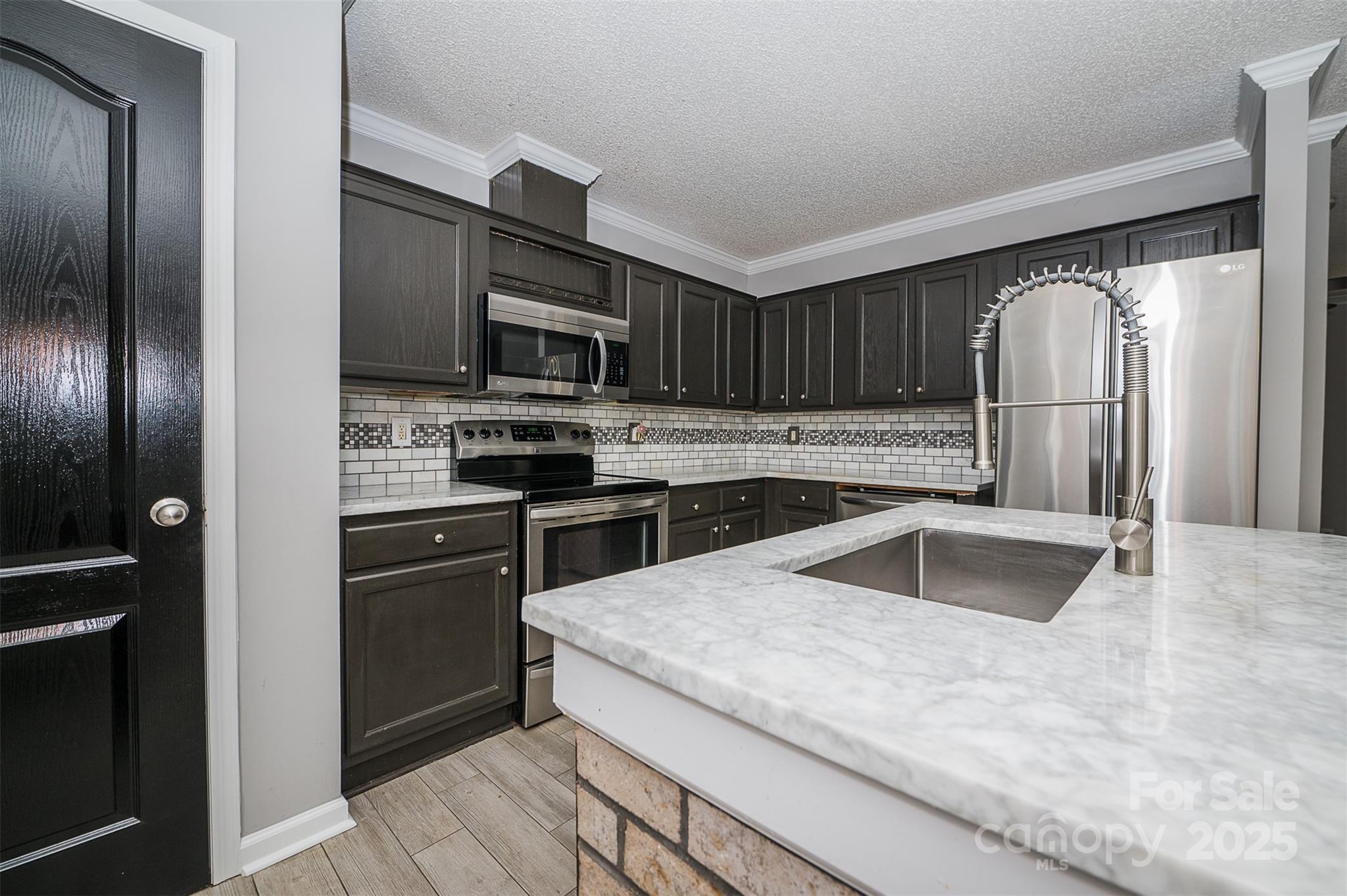 8226 Malibu Road Mount Pleasant, NC 28124 - Photo 12 of 44 a kitchen with granite countertop a refrigerator and a sink