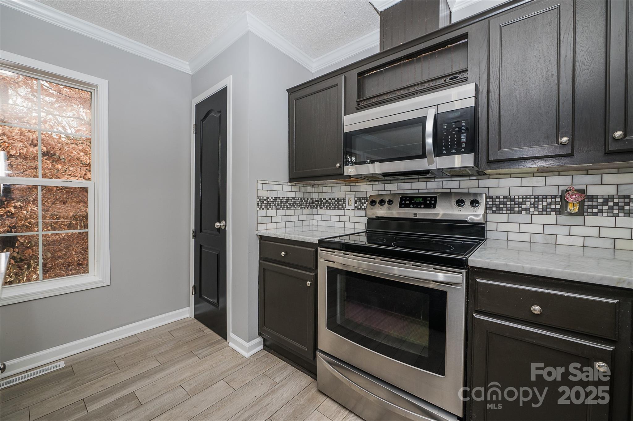 8226 Malibu Road Mount Pleasant, NC 28124 - Photo 13 of 44 a kitchen with granite countertop a stove and a microwave
