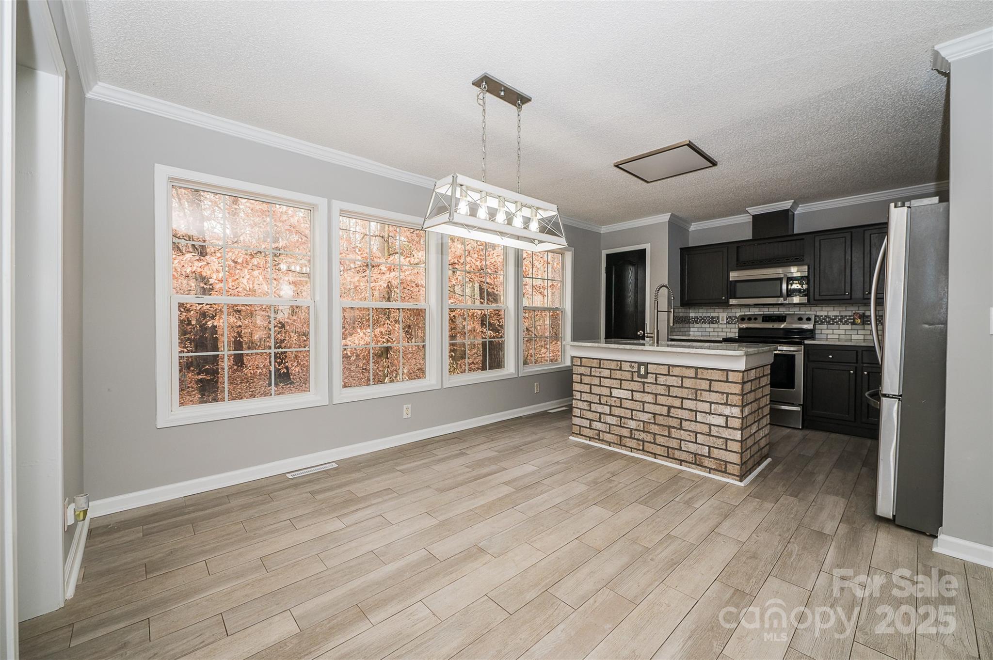 8226 Malibu Road Mount Pleasant, NC 28124 - Photo 15 of 44 a kitchen with stainless steel appliances kitchen island granite countertop a stove and a sink