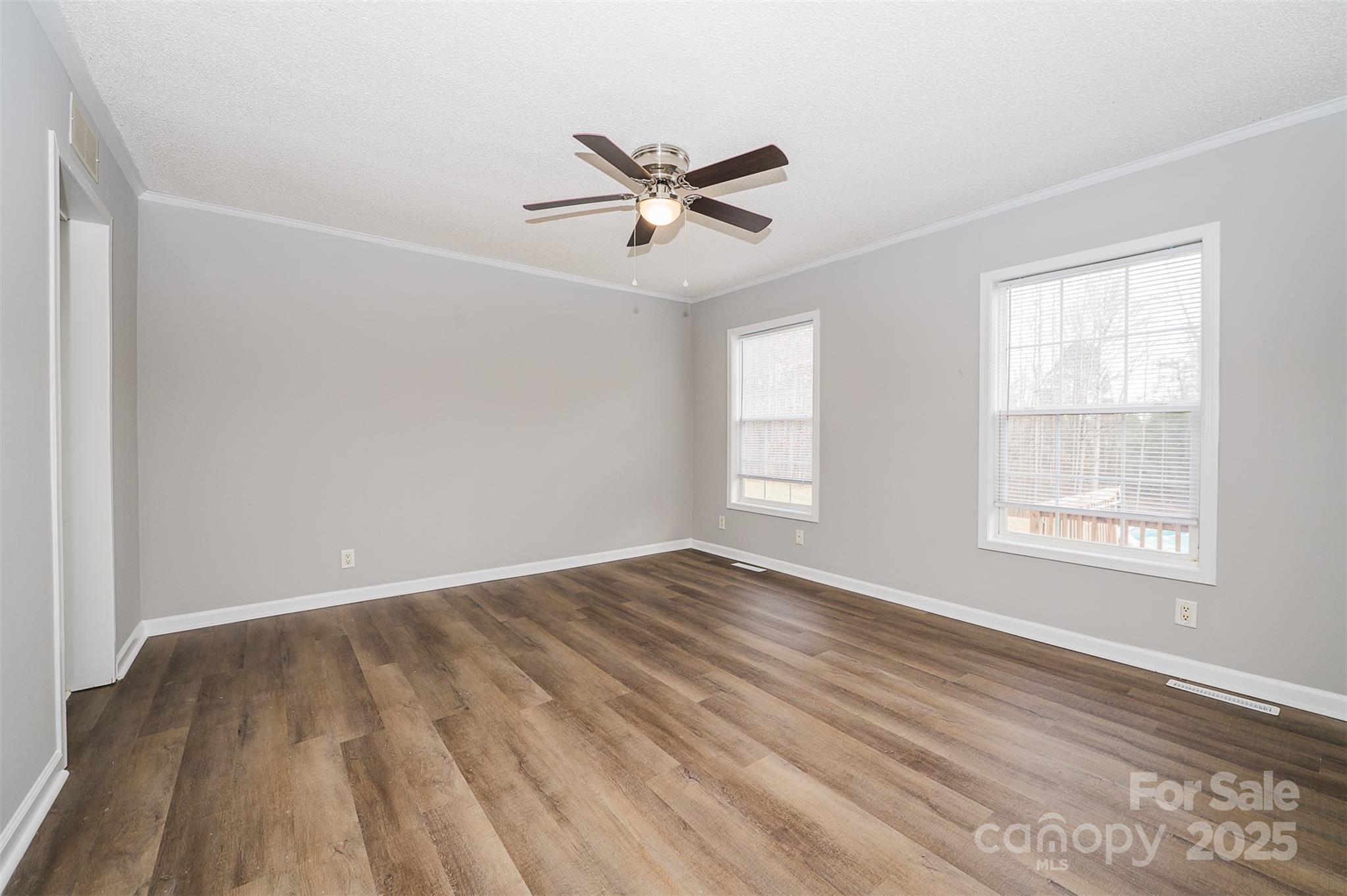 8226 Malibu Road Mount Pleasant, NC 28124 - Photo 18 of 44 a view of empty room with wooden floor and fan