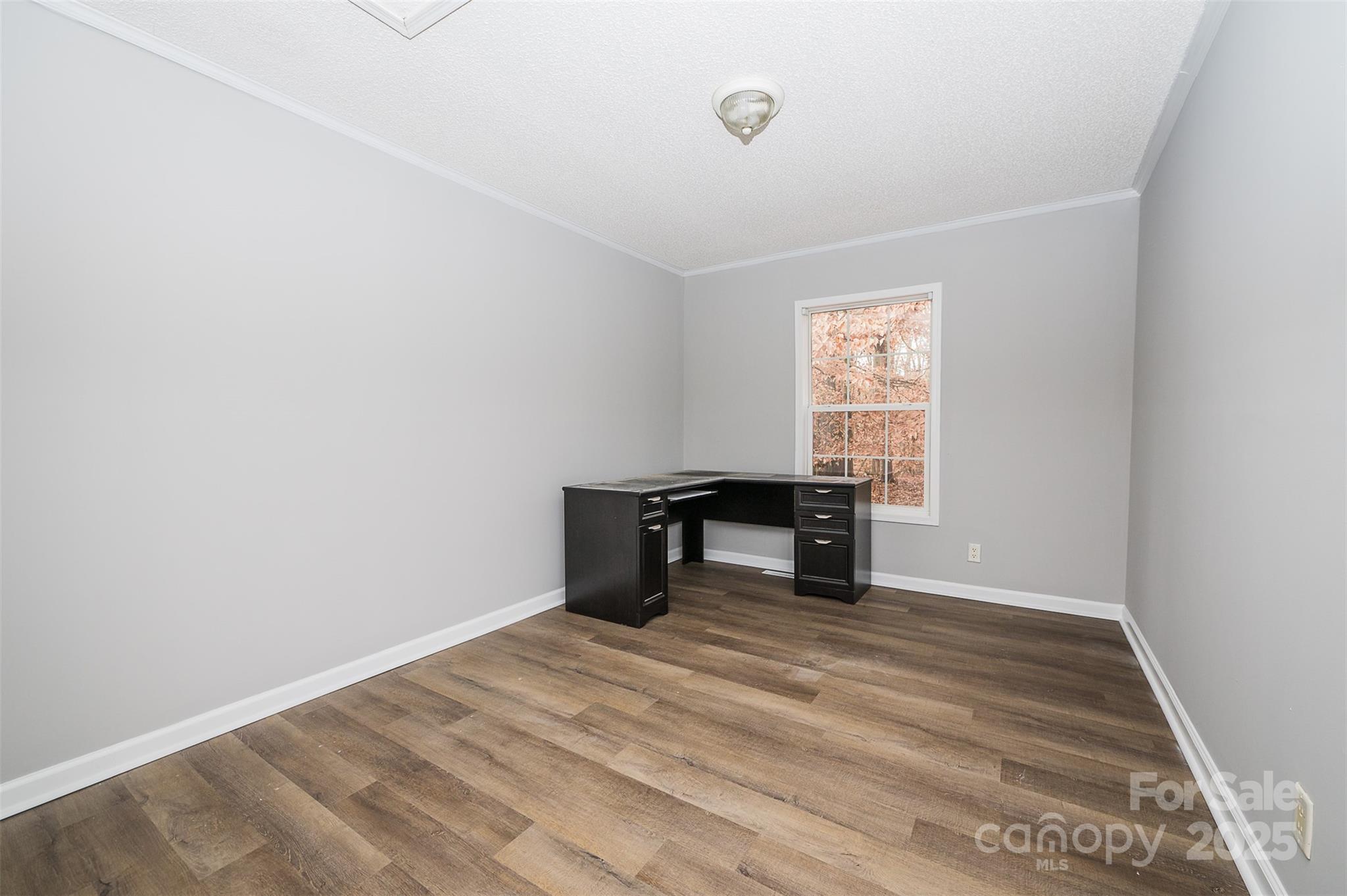 8226 Malibu Road Mount Pleasant, NC 28124 - Photo 24 of 44 a view of an empty room with wooden floor and a window