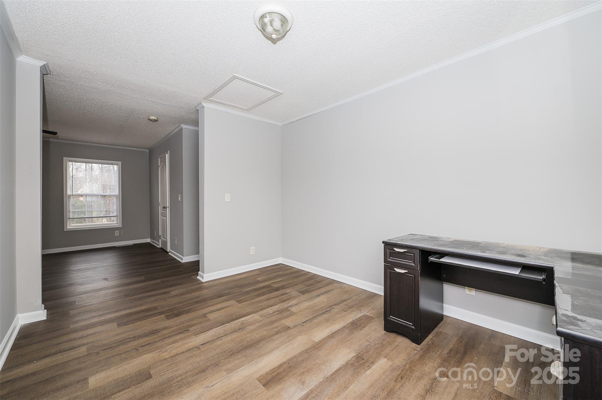 8226 Malibu Road Mount Pleasant, NC 28124 - Photo 25 of 44 a view of an empty room with wooden floor