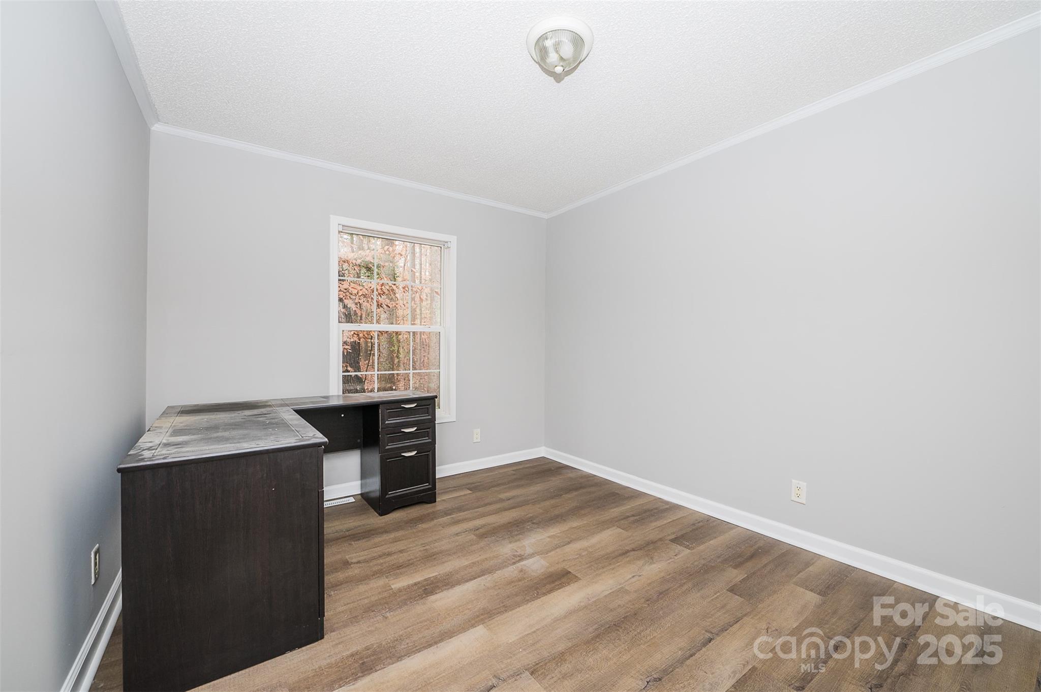 8226 Malibu Road Mount Pleasant, NC 28124 - Photo 26 of 44 an empty room with wooden floor cabinet and windows