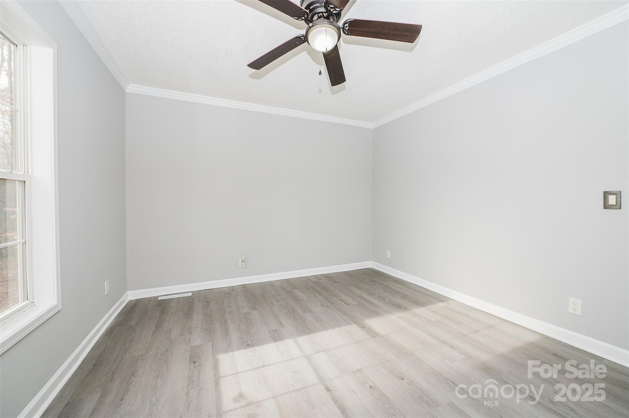 8226 Malibu Road Mount Pleasant, NC 28124 - Photo 27 of 44 an empty room with a window and a fan