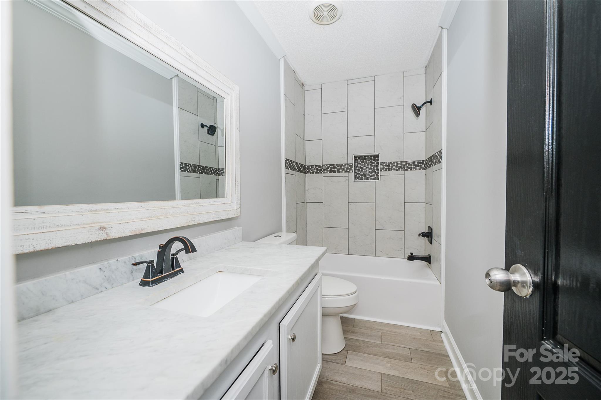 8226 Malibu Road Mount Pleasant, NC 28124 - Photo 28 of 44 a bathroom with a tub sink toilet and mirror