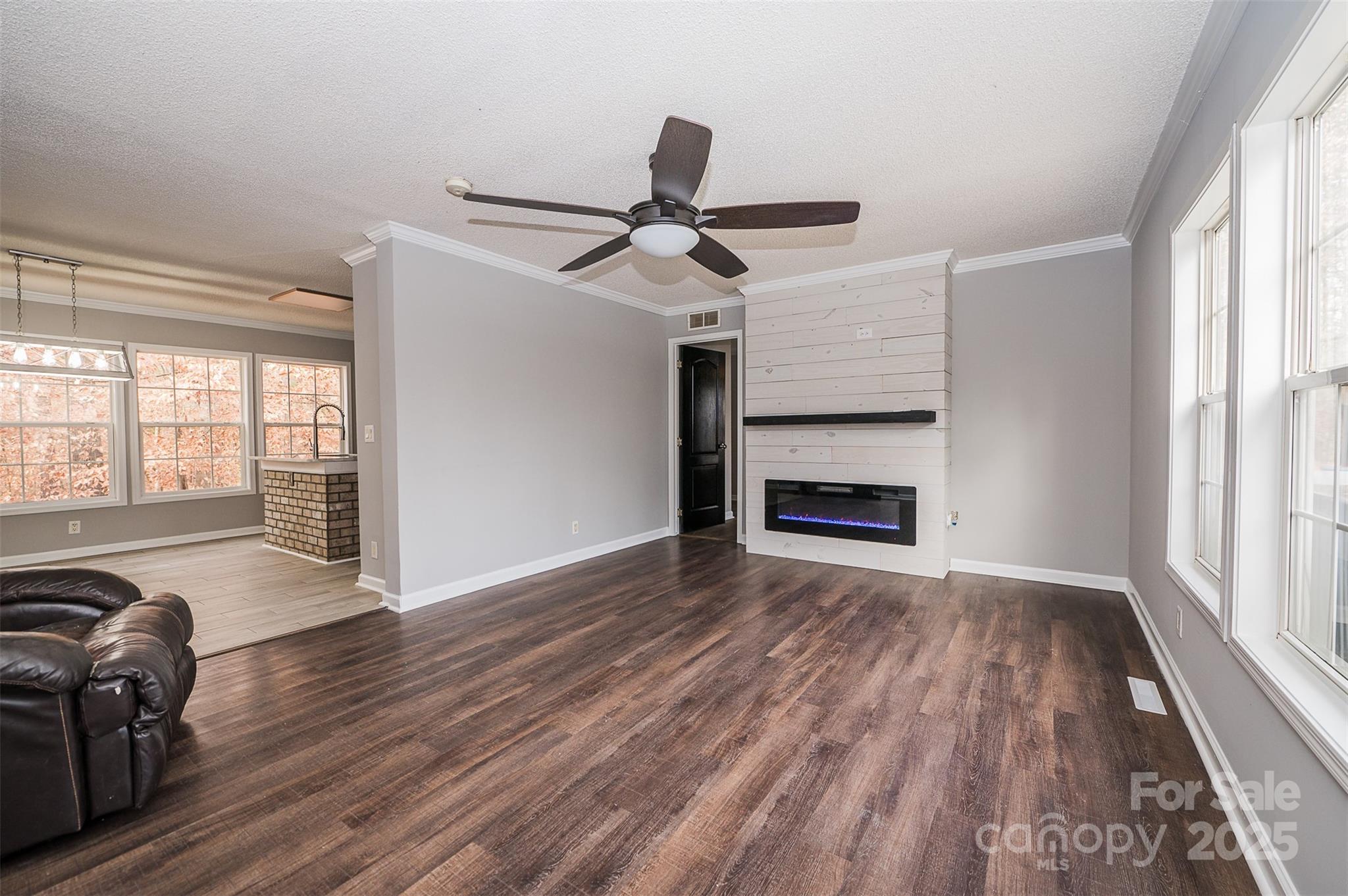 8226 Malibu Road Mount Pleasant, NC 28124 - Photo 5 of 44 a view of empty room with wooden floor and fan