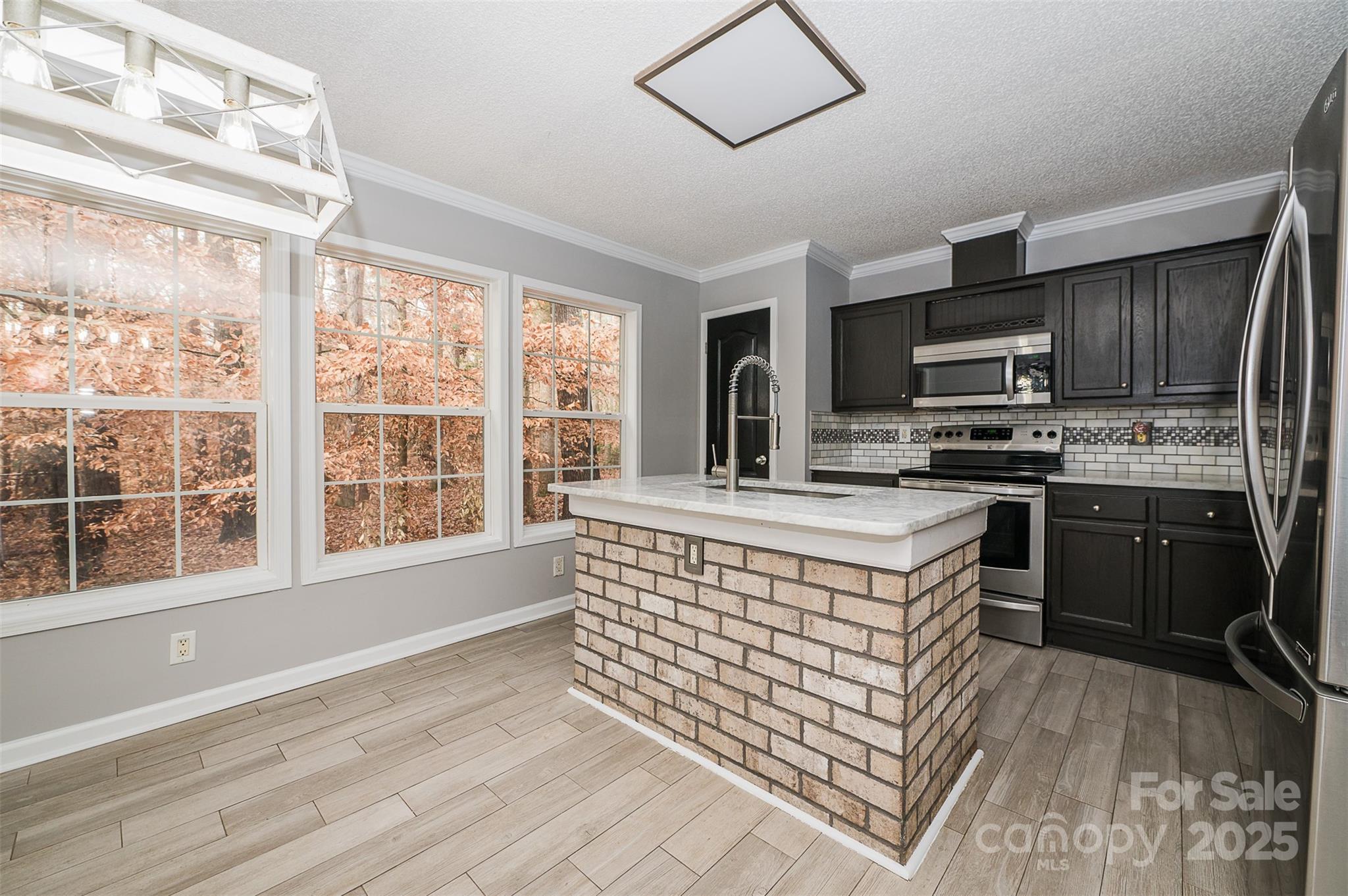 8226 Malibu Road Mount Pleasant, NC 28124 - Photo 10 of 44 a kitchen with stainless steel appliances granite countertop a stove a sink and a microwave