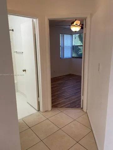 a view of an entryway and wooden floor