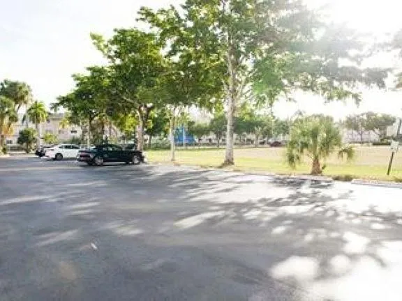 a view of yard with swimming pool and trees