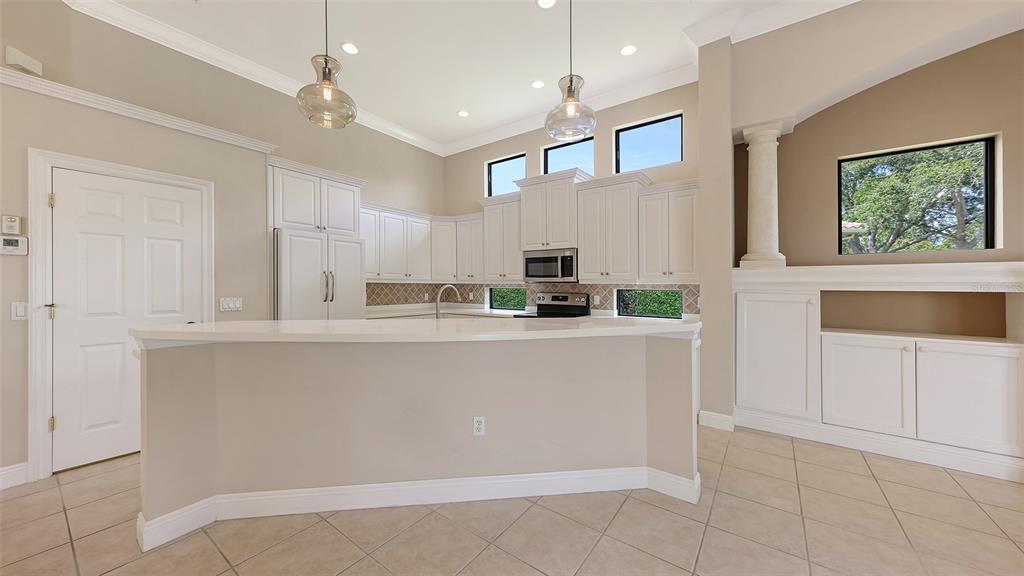 7134 Whitemarsh Circle Lakewood Ranch, FL 34202 - Photo 18 of 78 a kitchen with stainless steel appliances a refrigerator sink and cabinets