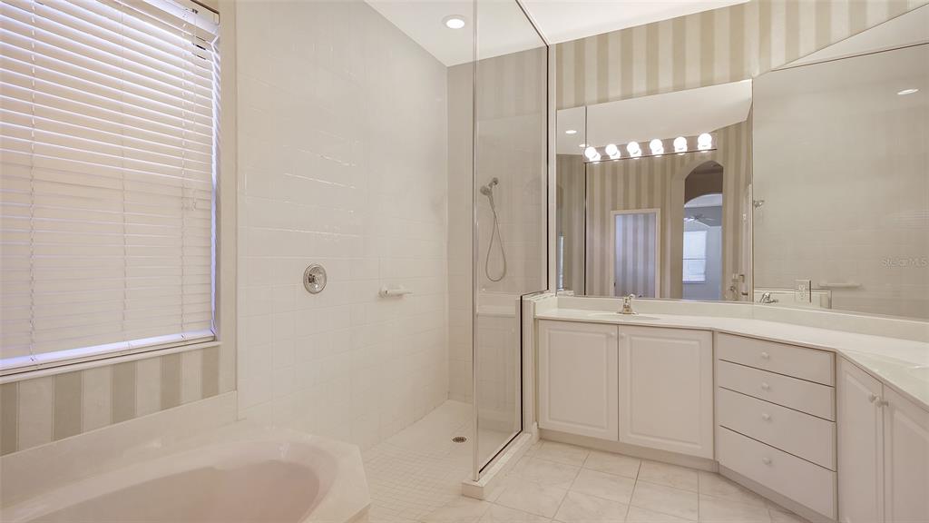 7134 Whitemarsh Circle Lakewood Ranch, FL 34202 - Photo 36 of 78 a bathroom with a double vanity sink and mirror with bathtub