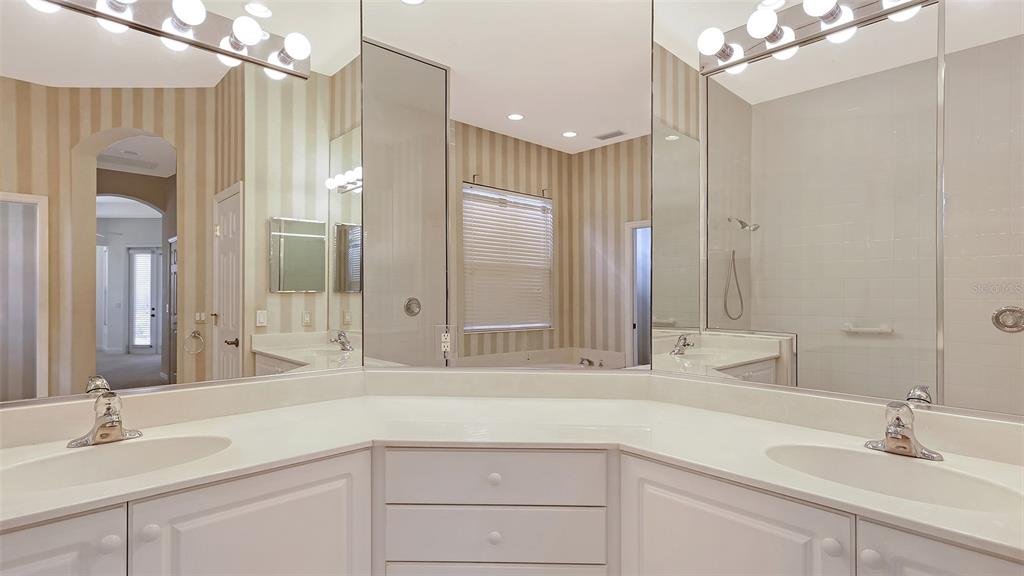 7134 Whitemarsh Circle Lakewood Ranch, FL 34202 - Photo 39 of 78 a bathroom with a sink vanity granite tub and a mirror
