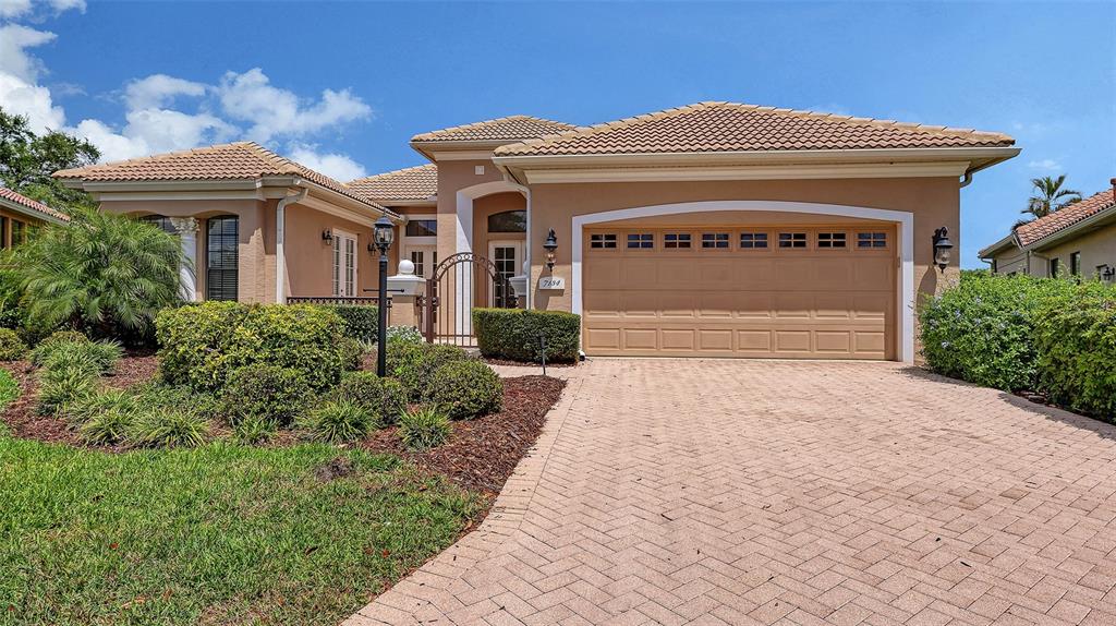 7134 Whitemarsh Circle Lakewood Ranch, FL 34202 - Photo 4 of 78 a front view of a house with a yard and garage