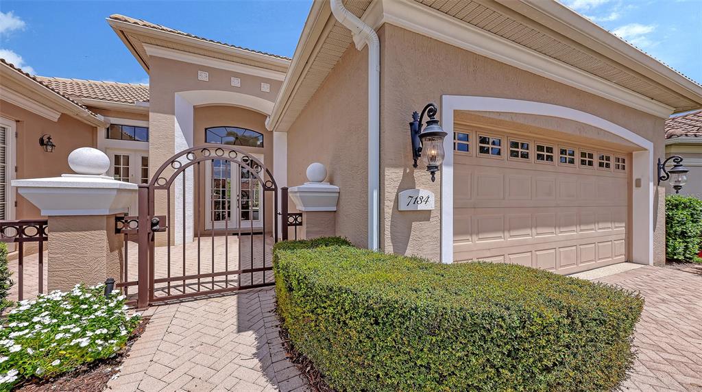 7134 Whitemarsh Circle Lakewood Ranch, FL 34202 - Photo 5 of 78 a front view of a house with garden