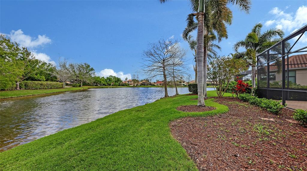 7134 Whitemarsh Circle Lakewood Ranch, FL 34202 - Photo 57 of 78 a view of a lake with a building in the background