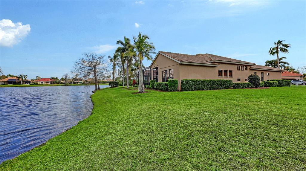 7134 Whitemarsh Circle Lakewood Ranch, FL 34202 - Photo 58 of 78 a view of a house with a yard and potted plants