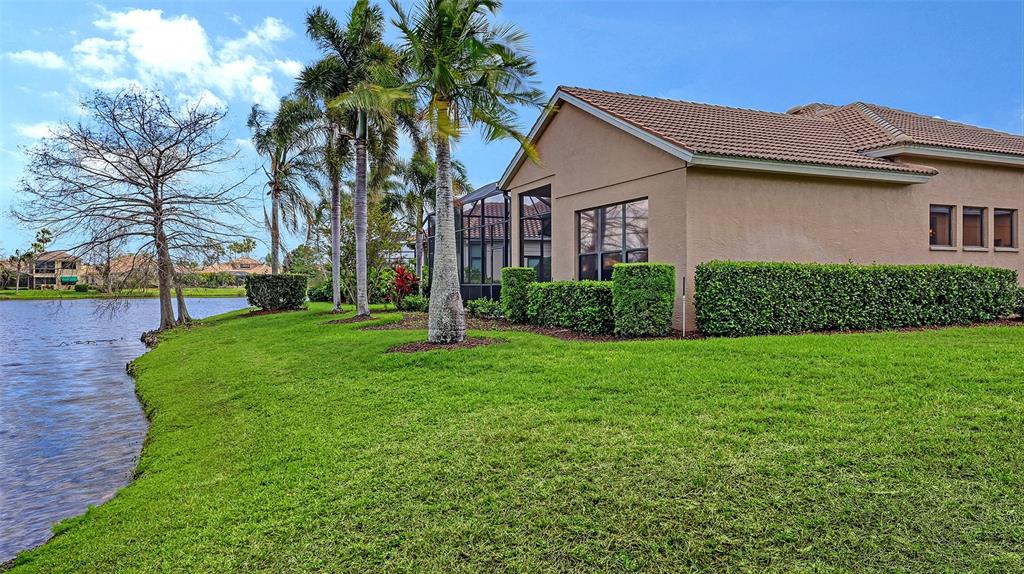 7134 Whitemarsh Circle Lakewood Ranch, FL 34202 - Photo 59 of 78 a front view of a house with a garden