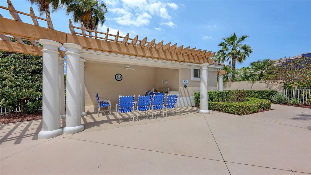 7134 Whitemarsh Circle Lakewood Ranch, FL 34202 - Photo 64 of 78 a view of a house with a small yard and a large tree