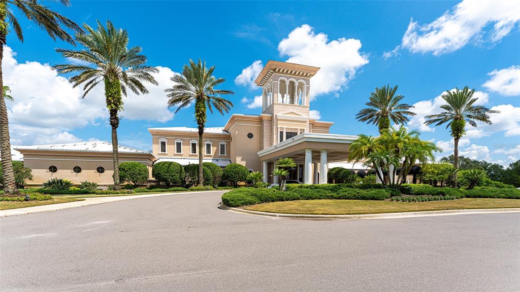7134 Whitemarsh Circle Lakewood Ranch, FL 34202 - Photo 69 of 78 a front view of multi story residential apartment building with yard and sign board