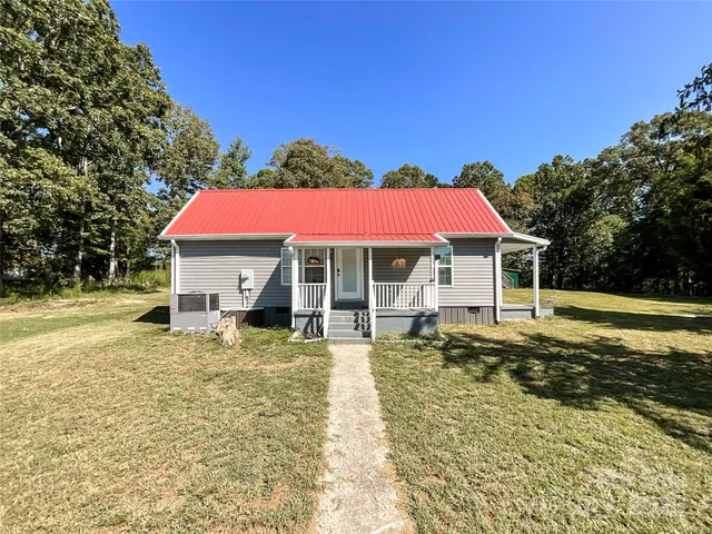 a view of a house with swimming pool and sitting area