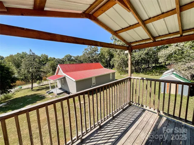 a view of a balcony with wooden floor and outdoor space