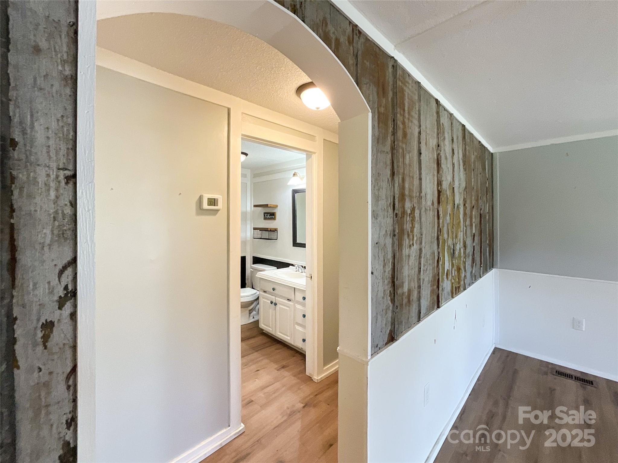 680 Mullinax Circle Blacksburg, SC 29702 - Photo 5 of 25 a view of a hallway with wooden floor and a bathroom