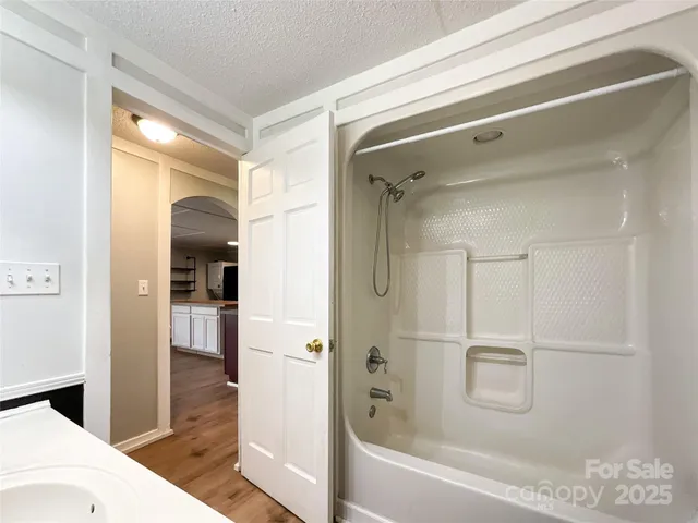 a bathroom with a shower and a bath tub