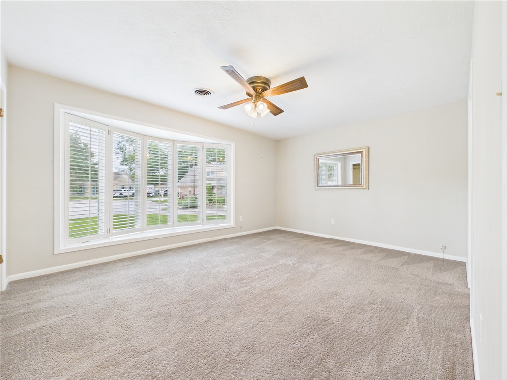 902 Briar Bend Court Bryan, TX 77802 - Photo 14 of 39 a view of a livingroom with a ceiling fan and window