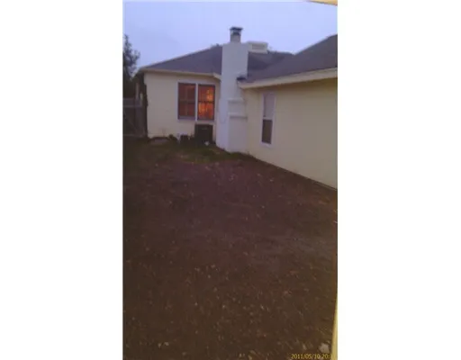 a view of a house with a small yard