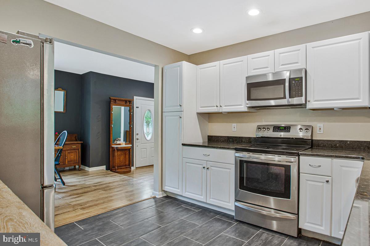 976 Shore Acres Road Arnold, MD 21012 - Photo 14 of 40 a kitchen with stainless steel appliances granite countertop a stove microwave and cabinets