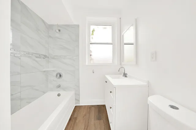a bathroom with a sink a toilet and a bathtub